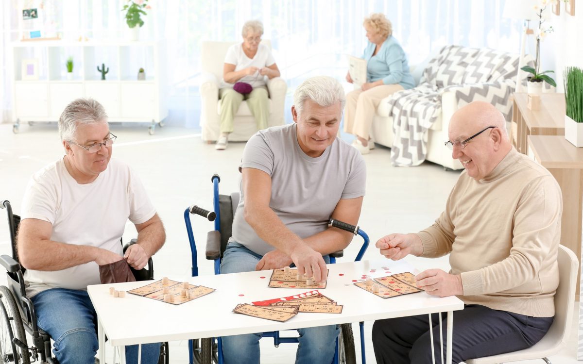 Senior people playing lotto at care home