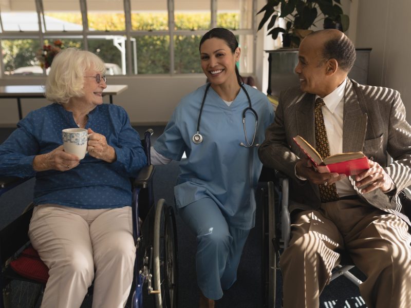 front-view-female-doctor-talking-with-disable-senior-couple-home-scaled-1.jpg